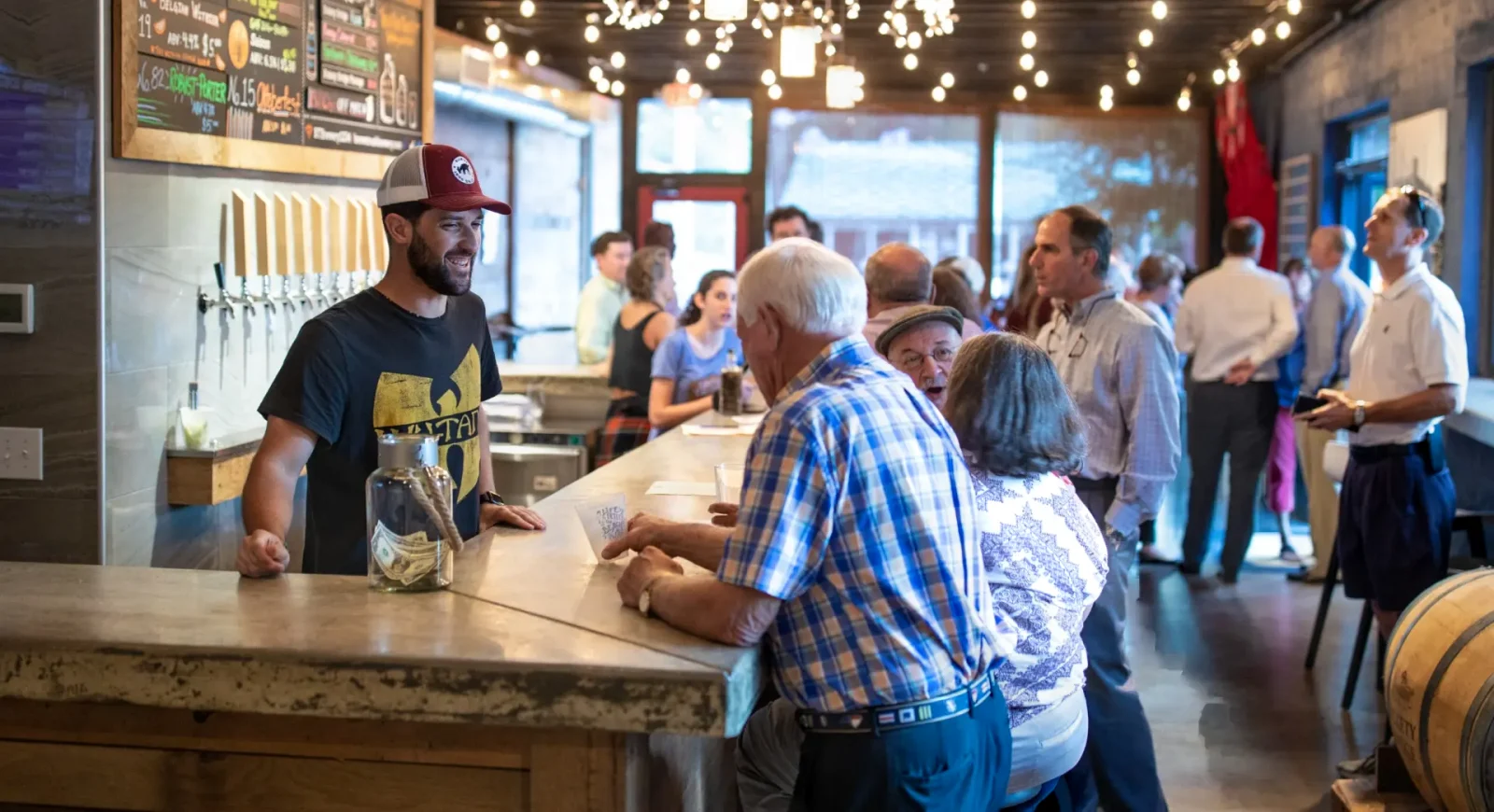 A customer talks to a bartender at Brown Truck Brewing in High Point, North Carolina